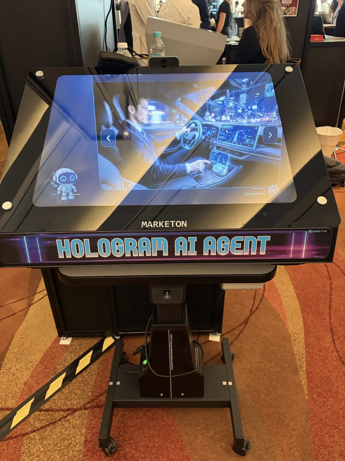 A hologram AI agent display at the Marketon booth.