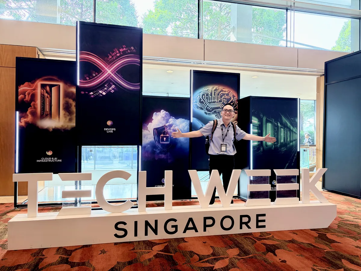 Harry standing behind the Tech Week Singapore lettering at the event display.